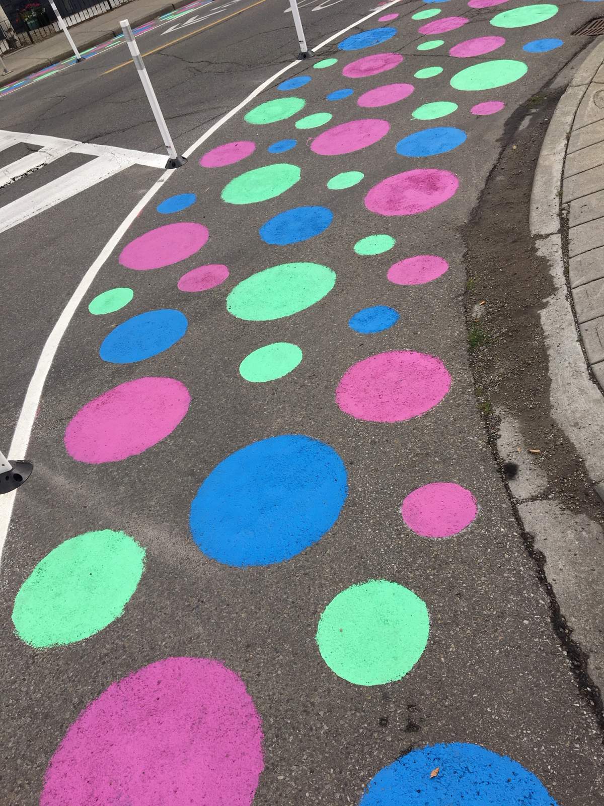 Brightly coloured polka dots line an intersection in Bridgeland.