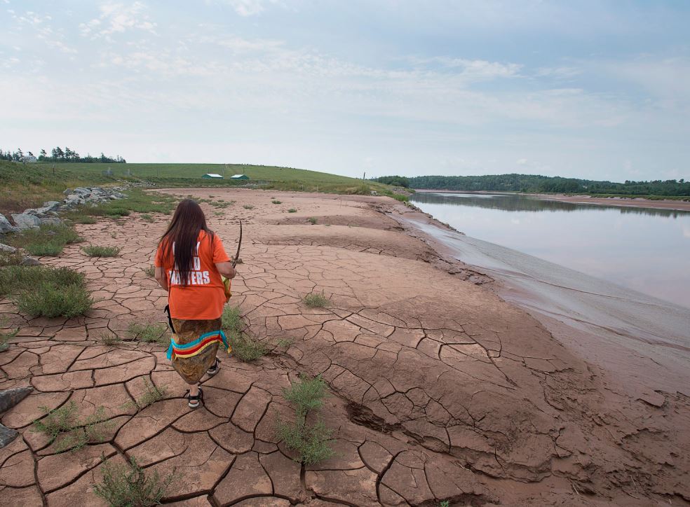 Mi'kmaq activist Dorene Bernard walks on the shores of the Shubenacadie River, a 72-kilometre tidal river that cuts through the middle of Nova Scotia and flows into the Bay of Fundy, in Fort Ellis, N.S. on Tuesday, July 31, 2018. Alton Natural Gas Storage LP plans to build natural gas storage caverns in salt beds nearby and the company will gradually release a brine solution into the river system over a two- to three-year period. 