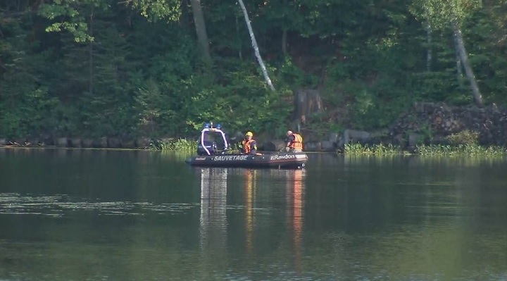 Emergency crews search for a missing swimmer in Lac Pontbriand on Sunday, Aug. 12, 2018.