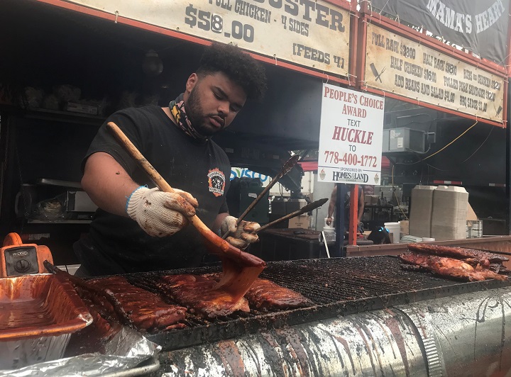 About the only smoke rising into the sky on Saturday in Kelowna was at Ribfest in City Park, where plenty of barbecue-style food was being cooked. Here, Victor McDonald of London, Ont., slathers on the barbecue sauce.