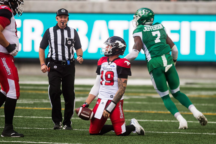 Calgary Stampeders quarterback Bo Levi Mitchell (19) looks on after getting sacked by Saskatchewan Roughriders defensive lineman Willie Jefferson (7) during first half CFL action in Regina on Sunday, August 19, 2018. 
