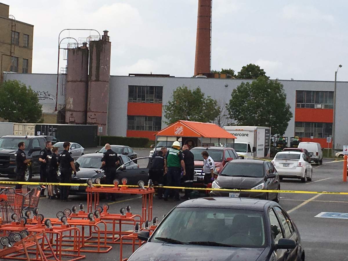 Paramedics tend to Sandra Finn who shot inside a vehicle in the parking lot of The Home Depot in Peterborough on Aug. 22, 2018.