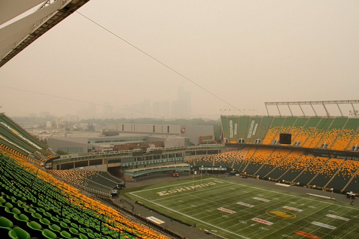 A smoky haze is seen over Commonwealth Stadium on Aug. 15, 2018.