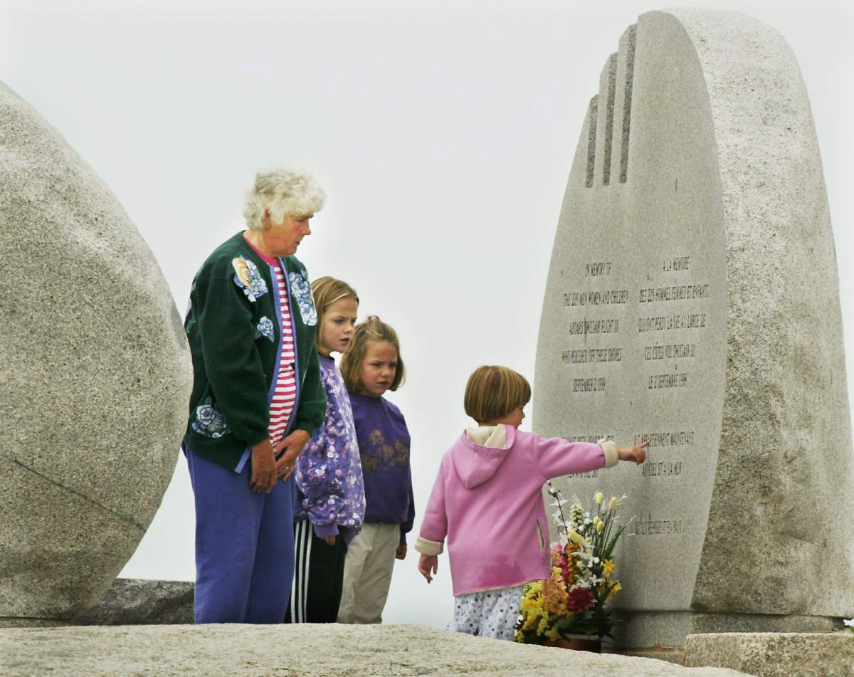 Visitors view the Swissair Flight 111 memorial at Whalesback near Peggy’s Cove N. S. on Monday, Sept. 1, 2003.