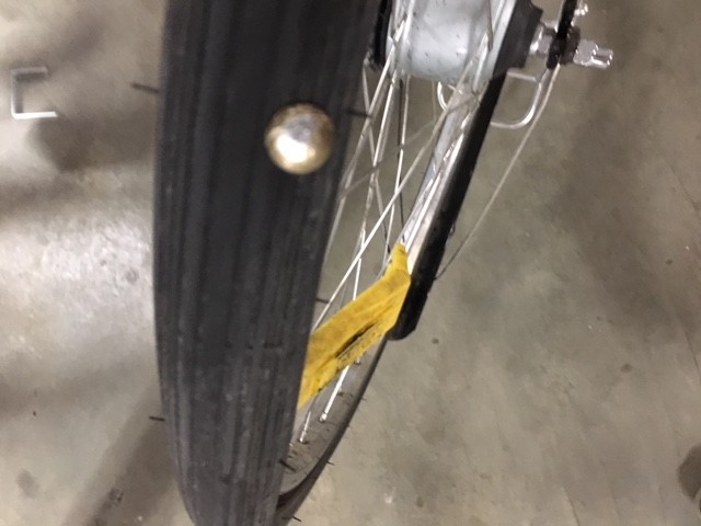 A photo of a tack in a bike wheel.