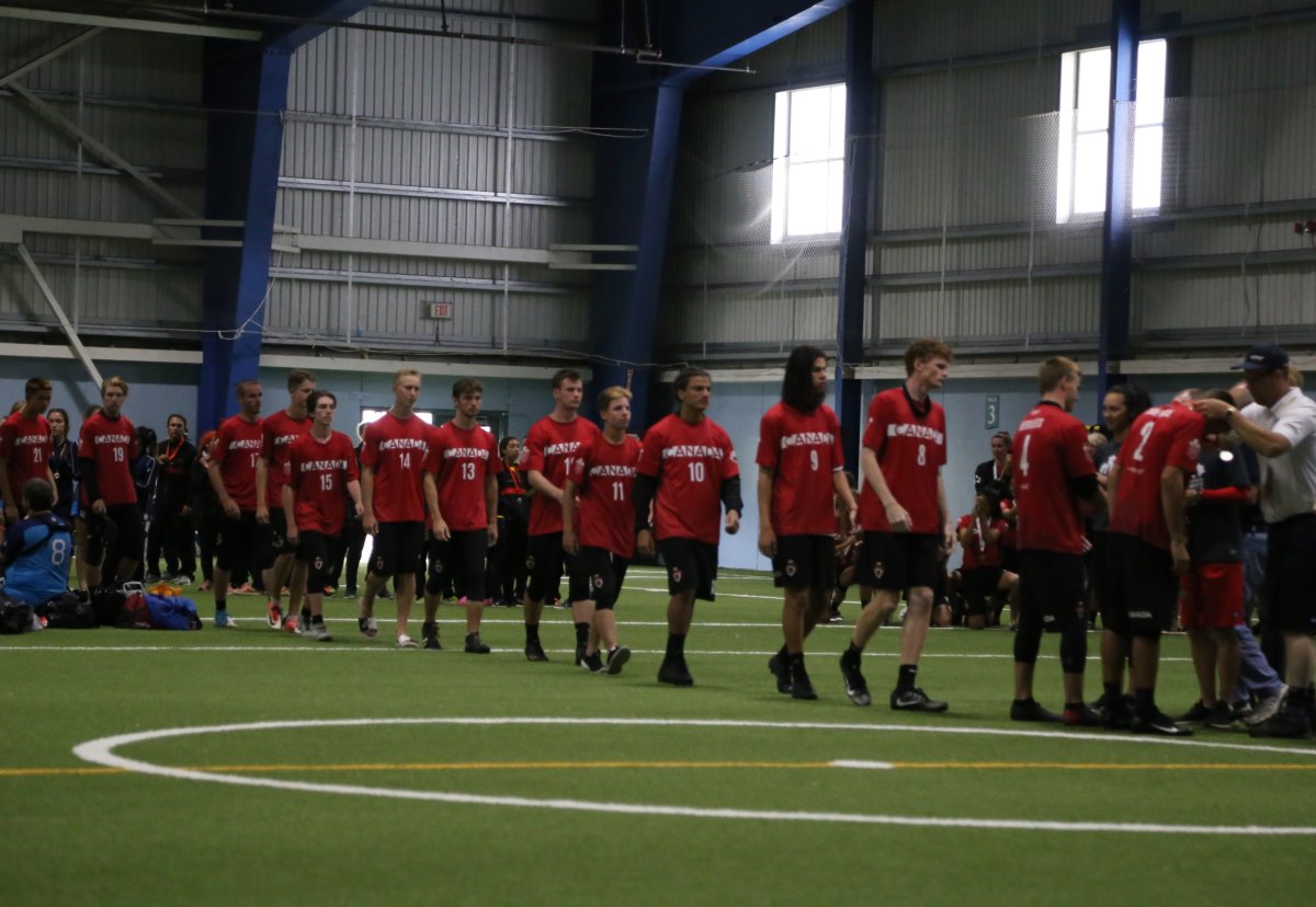 Team Canada's U20 Ultimate men's team accept their silver medals at the World Junior tournament in Waterloo.