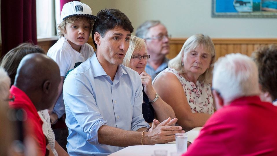 Prime Minister Justin Trudeau and his four-year-old son Hadrien meet with seniors at the Milton Community Hall in North Milton, P.E.I. on Aug. 13, 2018.
