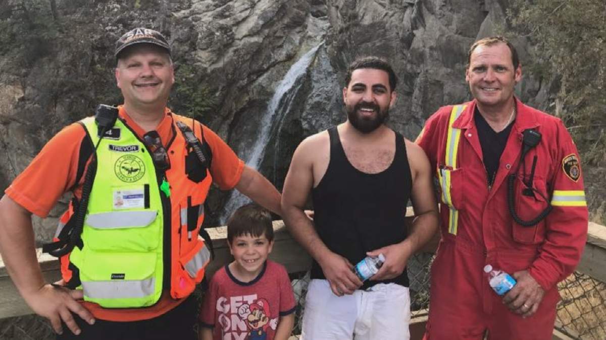 Ajami poses with two of his rescuers in front of Fintry Falls. He said many couldn’t believe he survived the fall.