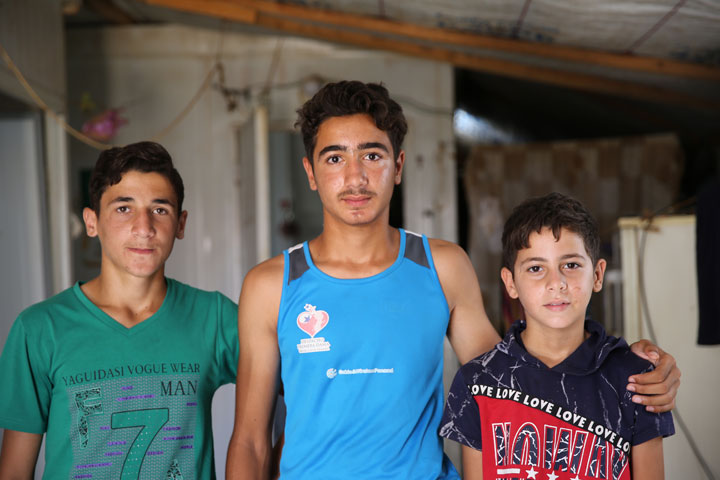 Mohammed Nakash with his little brother and his friend, who all participated in the wrestling program at Zaatari Camp.