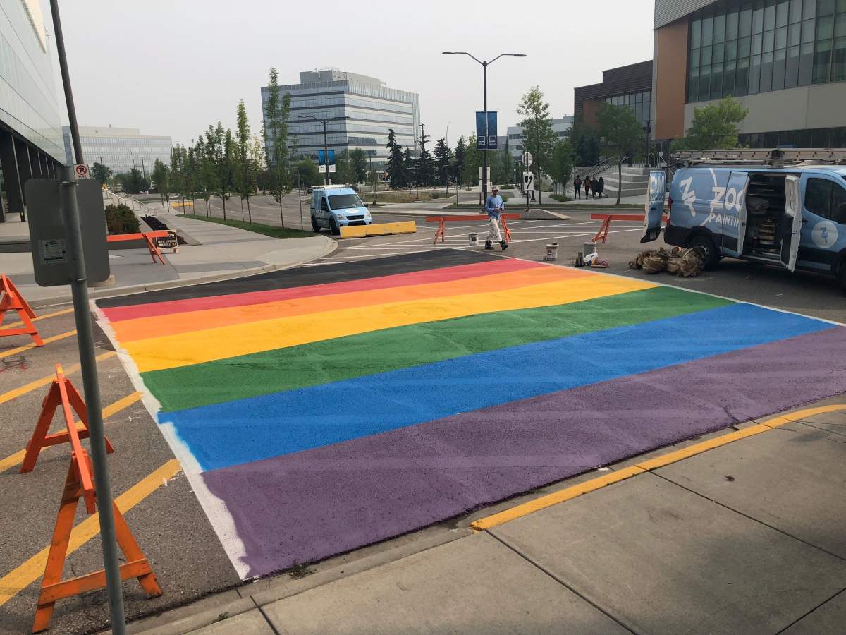 Zoom Painting crews are seen at the permanent rainbow crosswalk on the MRU campus.