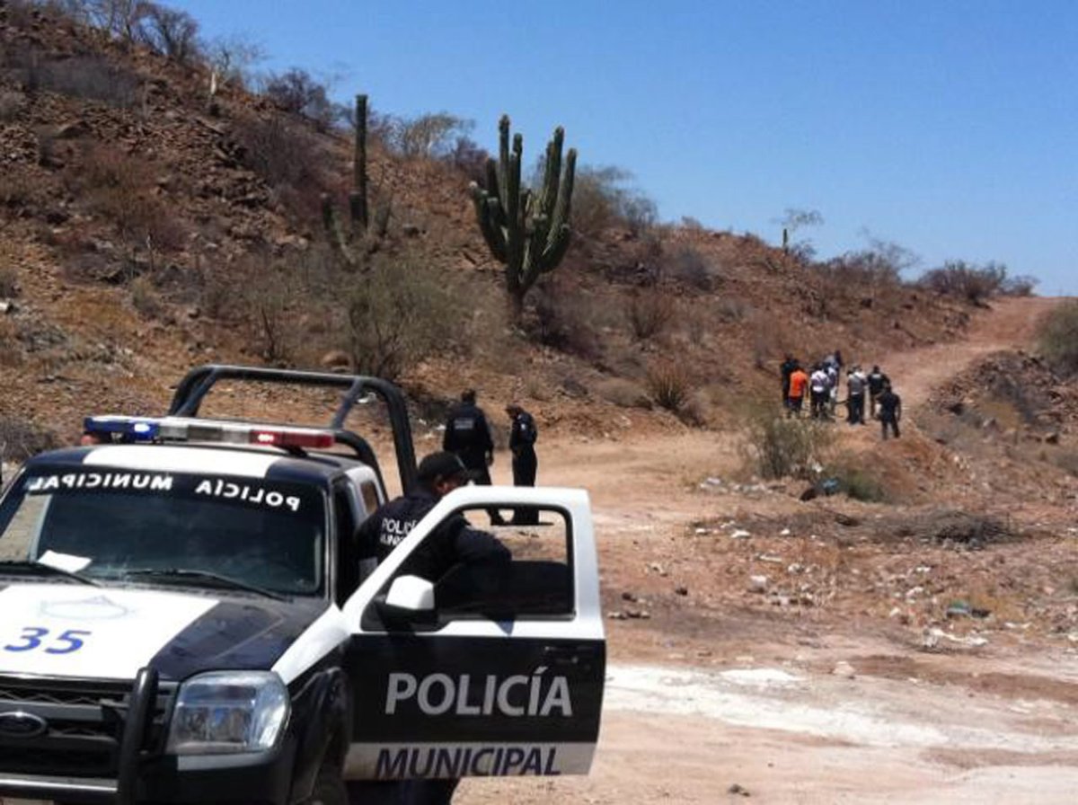 Police secure the area where the body of Mexican police reporter Marco Antonio Avila Garcia was found inside a black plastic bag on the side of a road near the city of Empalme, south of Ciudad Obregon, in Sonora state, Mexico, Friday, May 18, 2012. 