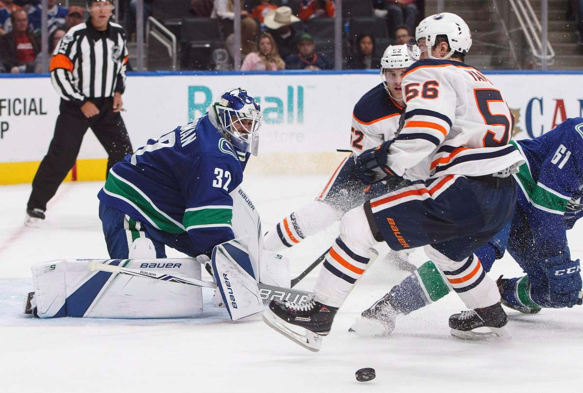 Vancouver Canucks' goalie Richard Bachman (32) makes the save on Edmonton Oilers' Kailer Yamamoto (56) during second period pre-season NHL action in Edmonton, Alta., on Friday September 22, 2017. 