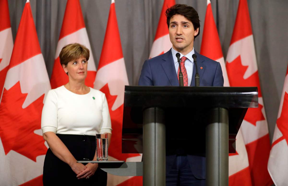 Canada’s Prime Minister Justin Trudeau speaks as Canada’s Minister of International Development Marie-Claude Bibeau stands alongside during a press conference at The Canadian High Commission in London, Thursday, April 19, 2018.