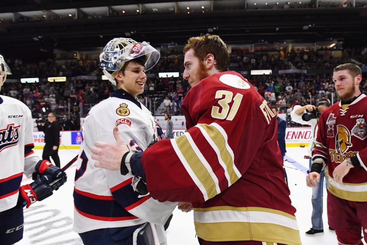 Regina Pats goalie Max Paddock, left, shakes hands with Acadie-Bathurst Titan goalie Evan Fitzpatrick after the Titan defeated the Pats to win the Memorial Cup final in Regina on Sunday, May 27, 2018.
