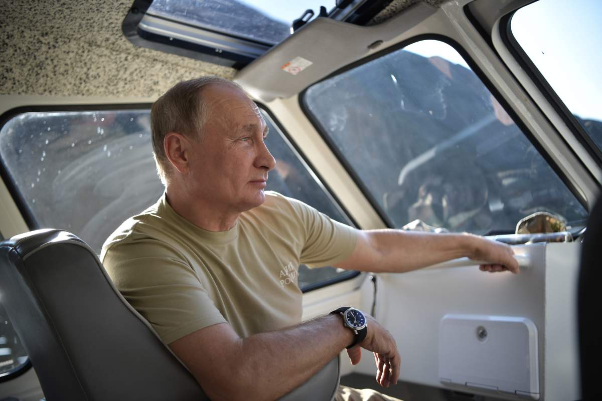 Putin sitting in a boat during his visit in the Tuva region in Siberia, Russia, on Aug. 26.