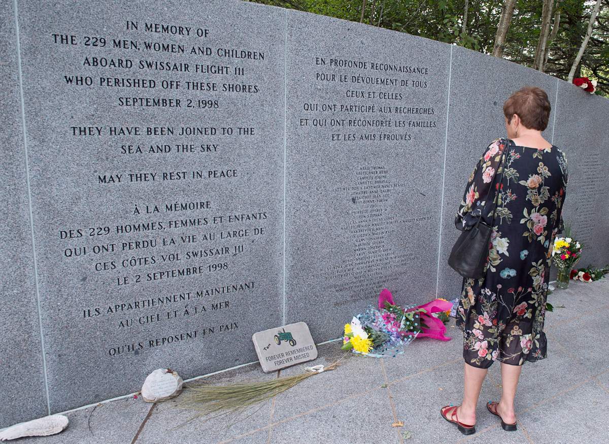 Family and friends attend a service at the Swissair Flight 111 memorial at Bayswater Beach, N.S. on Sunday, Sept. 2, 2018.