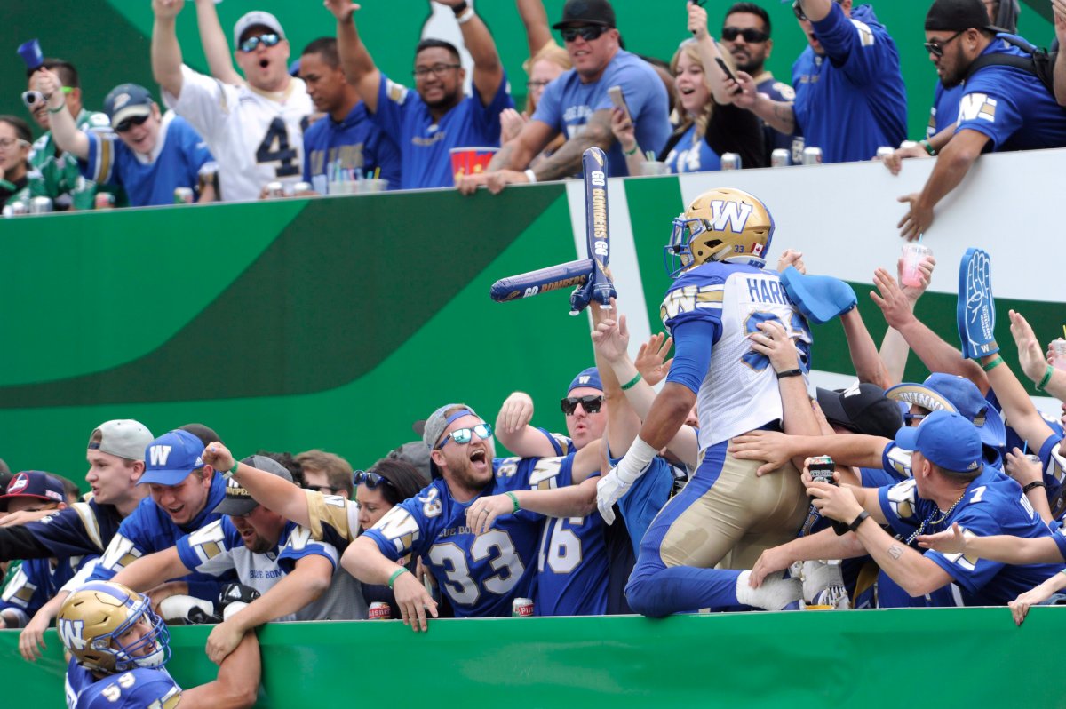 Winnipeg Blue Bombers' Andrew Harris celebrates with fans after a touchdown against the Saskatchewan Roughriders during first half CFL football action at Mosaic Stadium in Regina on Sunday, Sept. 2, 2018. 