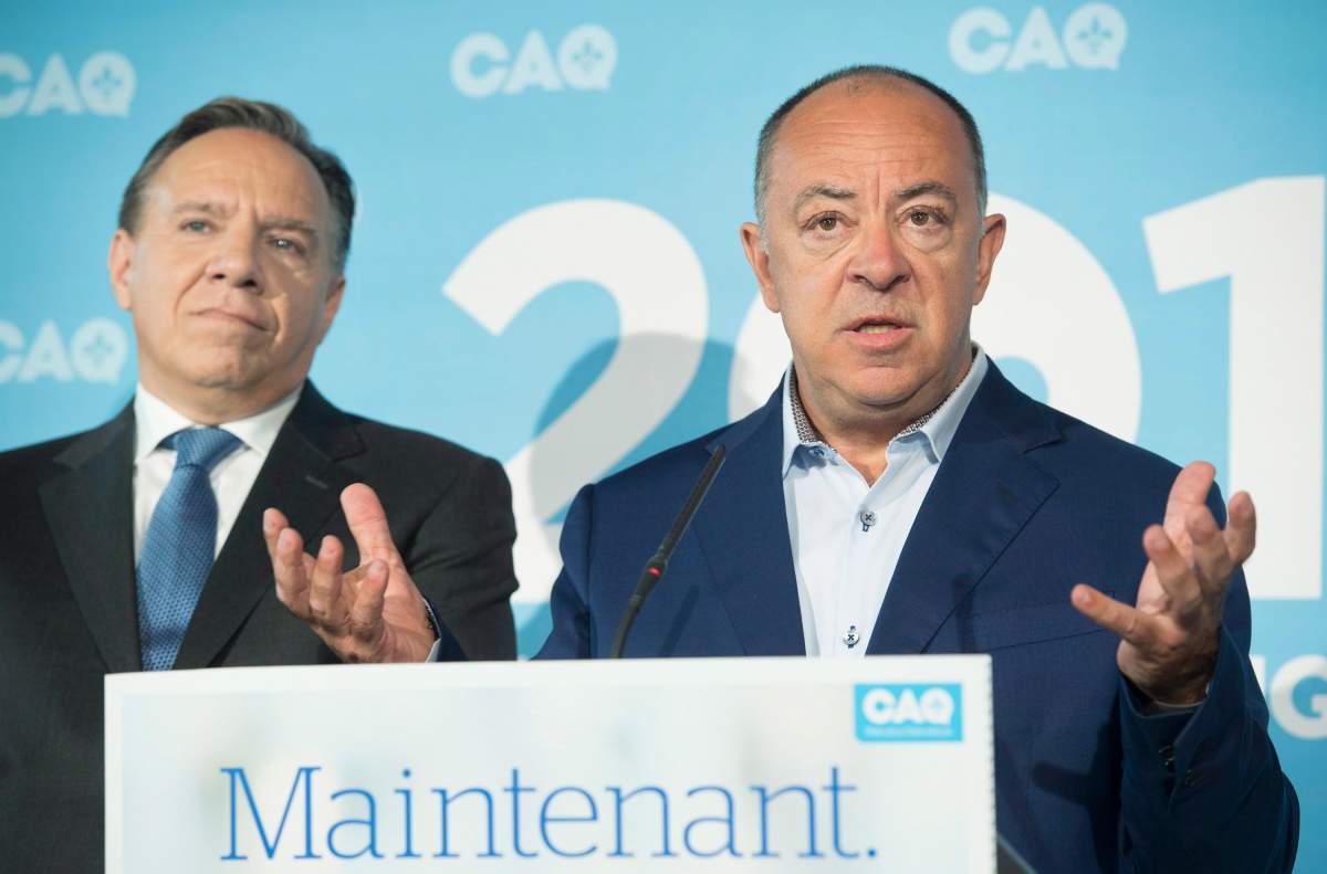 CAQ leader Francois Legault, left, looks on as Christian Dubé speaks during a campaign stop in La Prairie, Que., Monday, Sept. 3, 2018. Dube will be the CAQ candidate for the riding of La Prairie.