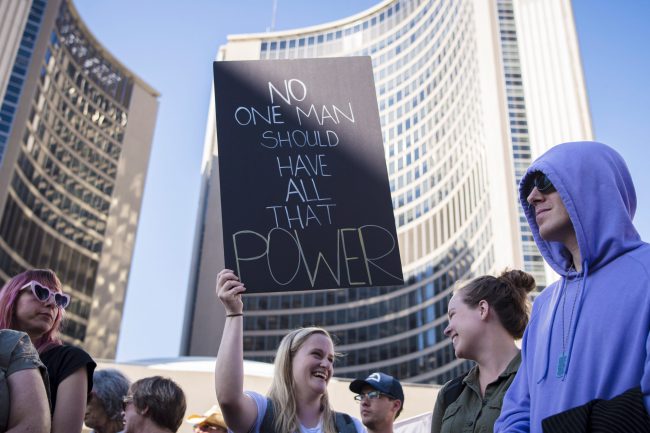 A protester attends the Fight Back against Ford: Rally to Save our Democracy and Rights event outside City Hall in Toronto, Sept. 12, 2018.