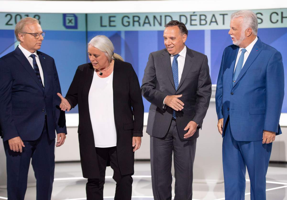PQ leader Jean-Francois Lisee left, Quebec Solidaire leader Manon Masse , CAQ leader Francois Legault and Liberal leader Philippe Couillard , pose for photos before their debate Thursday, September 13, 2018 in Montreal, Que..