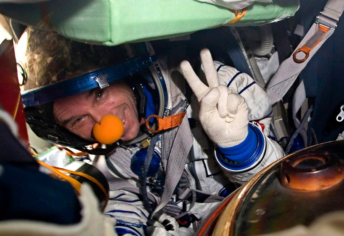 Space tourist Canadian billionaire and clown Guy Laliberte shows A victory sign while sitting inside the Soyuz TMA-14 spacecraft shortly after his landing with the members of the main mission to the International space station, Russian cosmonaut Gennady Padalka and NASA astronaut Michael Barratt, not seen, near the town of Arkalyk, Kazakhstan, on Sunday, Oct. 11, 2009. The federal tax court says the out-of-this-world trip taken by Quebec billionaire Guy Laliberte in 2009 is taxable. 