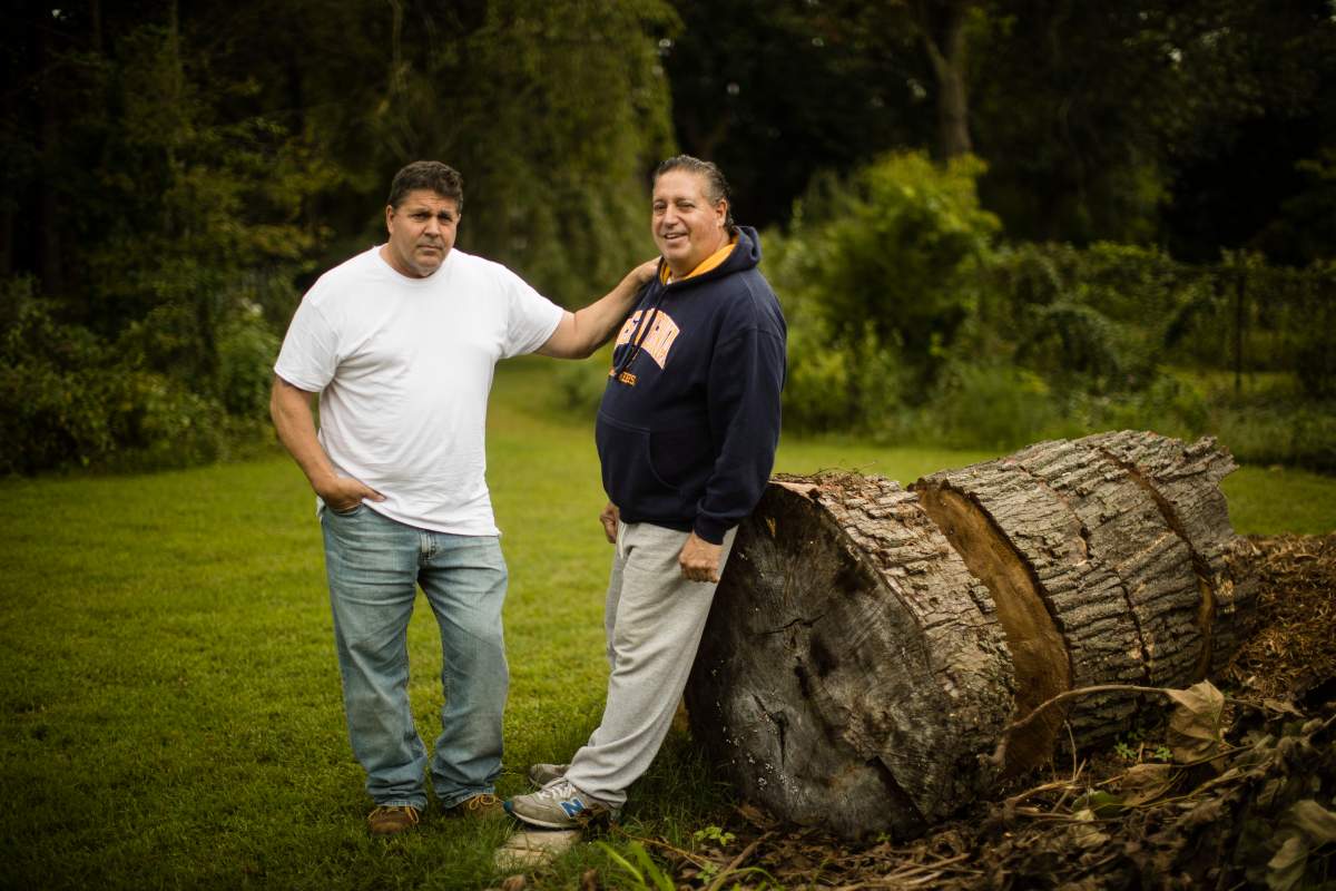 Anthony Torres, right, poses for a photograph with his brother Tom Torres, in Atco, N.J., Monday, Sept. 17, 2018. Anthony Torres says he was the rider caught shaving on a New Jersey Transit train in a video that went viral, explaining that he was just trying to clean up after days spent in a homeless shelter.
