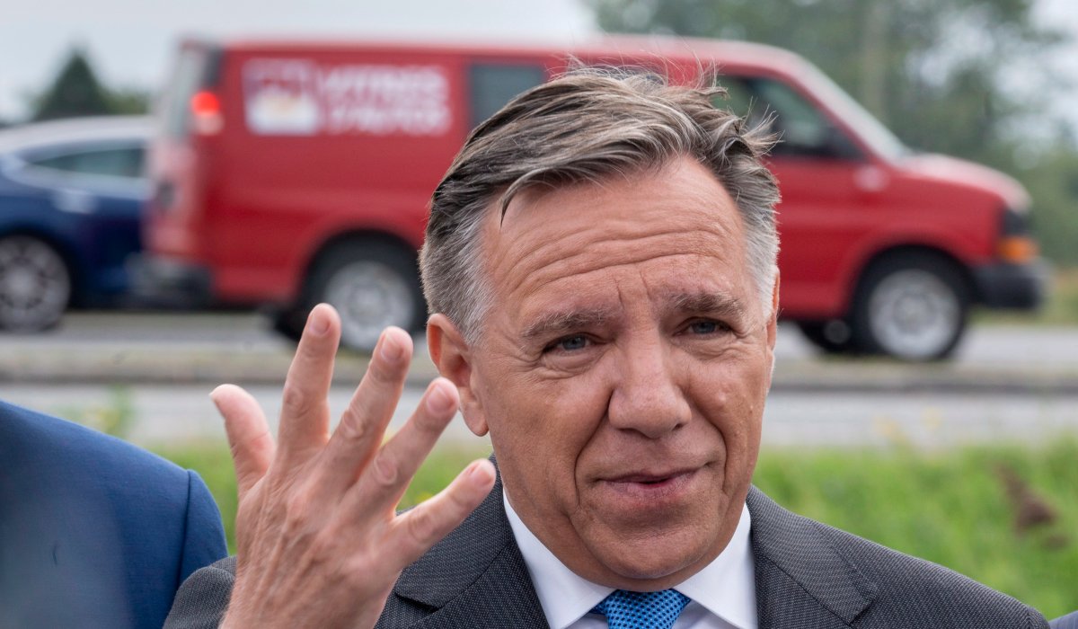 Coalition Avenir Québec Leader François Legault responds to questions during a news conference next to a busy highway in St-Hubert, Que., Tuesday, Sept. 18, 2018. 