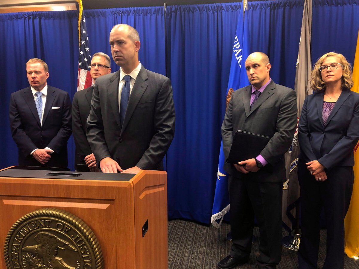 U.S. Attorney John Anderson, center at podium, speaks about the investigation into a fugitive Catholic priest who is accused of sex abuse at a news conference Friday, Sept. 21, 2018, in Albuquerque, N.M. 