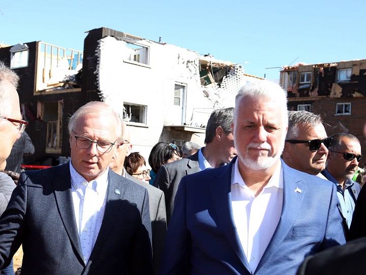 Quebec Liberal Leader Philippe Couillard (right) and Parti Québécois Leader Jean-François Lisée (left) survey the damage caused by a tornado, in Gatineau, Que., Saturday, September 22, 2018.
