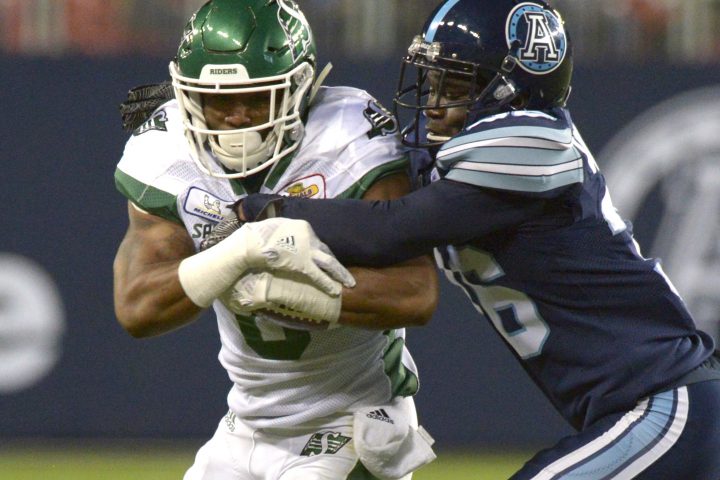Saskatchewan Roughriders Marcus Thigpen, left, is tackled by Toronto Argonauts Trumaine Washington during second half CFL action Saturday, September 22, 2018 in Toronto. 