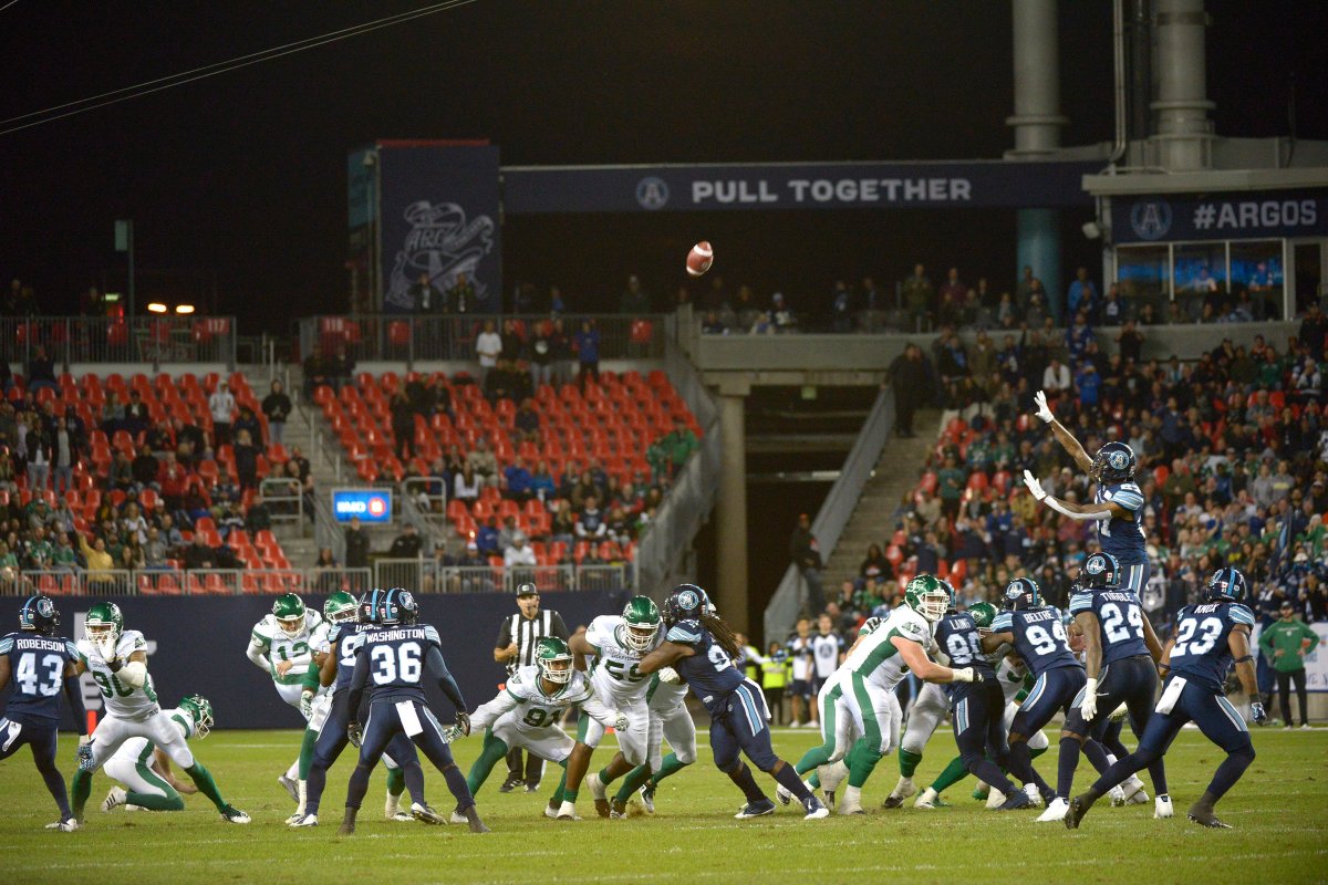 Saskatchewan Roughriders' Brett Lauther (fourth from left) kicks a game-winning field goal against the Toronto Argonauts during second half CFL action Saturday, September 22, 2018 in Toronto. 