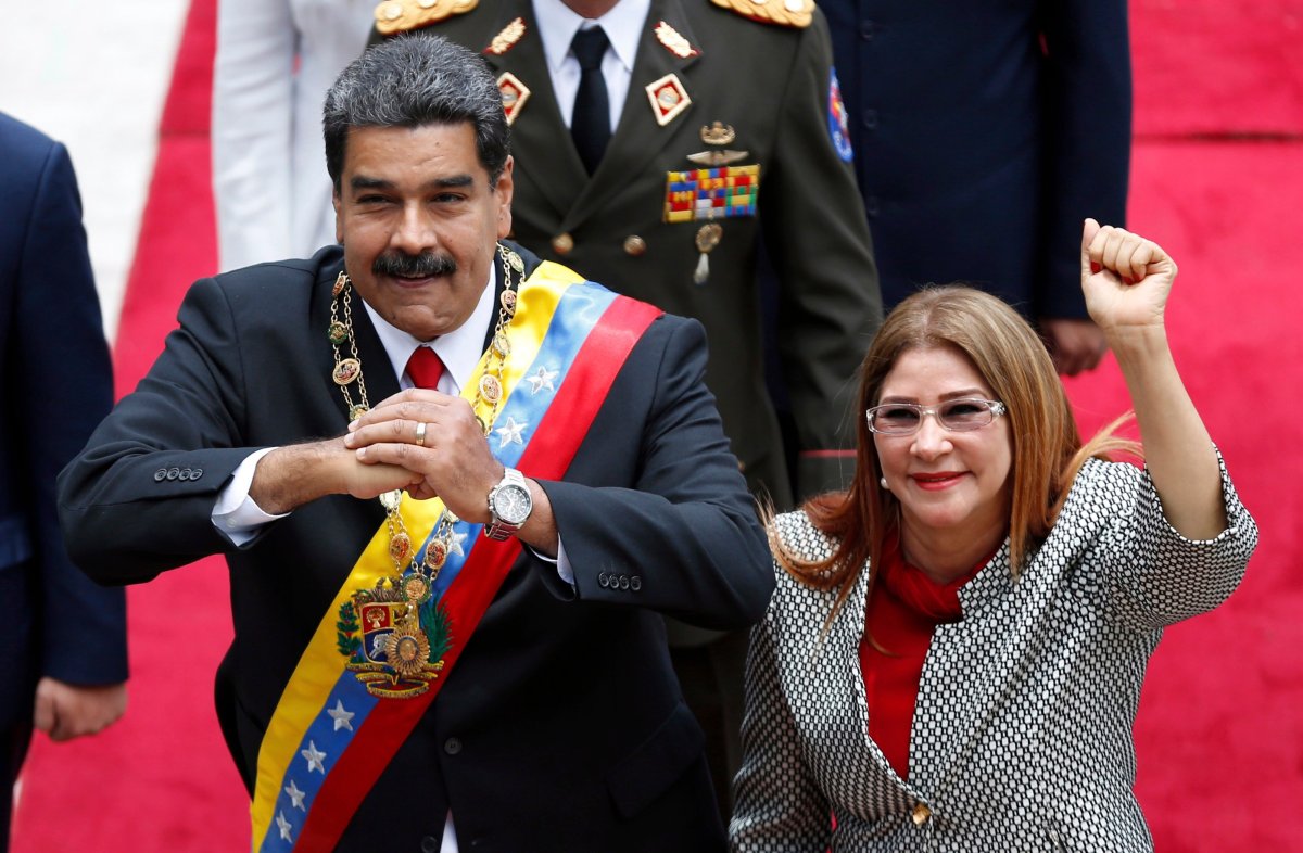 In this May 24, 2018 file photo, Venezuela's President Nicolas Maduro, left, and first lady Cilia Flores, acknowledge the press corps as they arrive for a session with the Constituent Assembly, in Caracas, Venezuela. Maduro has moved to assert even greater control over food distribution, handing out monthly boxes of staples that critics label a form of dictatorial social control. 