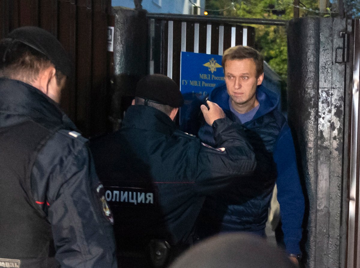 Police officers detain Russian opposition activist Alexei Navalny as he leaves a detention center after a month in jail for an unsanctioned protest rally, in Moscow, Russia, Monday, Sept. 24, 2018. 