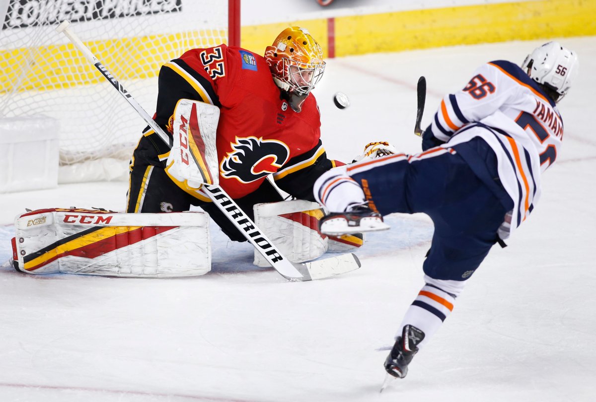 NHL player profile photo on Edmonton Oilers player Kailer Yamamoto, rt, scoring on Calgary Flames goalie David Rittich, from Czech Republic, during a game in Calgary, Canada on Sept. 17, 2018. THE CANADIAN PRESS IMAGES/Larry MacDougal.