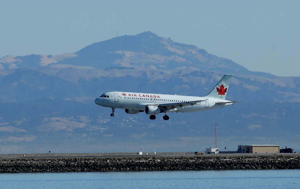 In this Oct. 24, 2017 file photo, an Air Canada plane prepares to land on a runway at San Francisco International Airport in San Francisco.