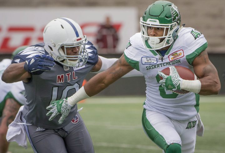 Montreal Alouettes' Henoc Muamba rushes in to tackle Saskatchewan Roughriders' Marcus Thigpen during first half CFL action in Montreal on Sunday, Sept. 30, 2018. 