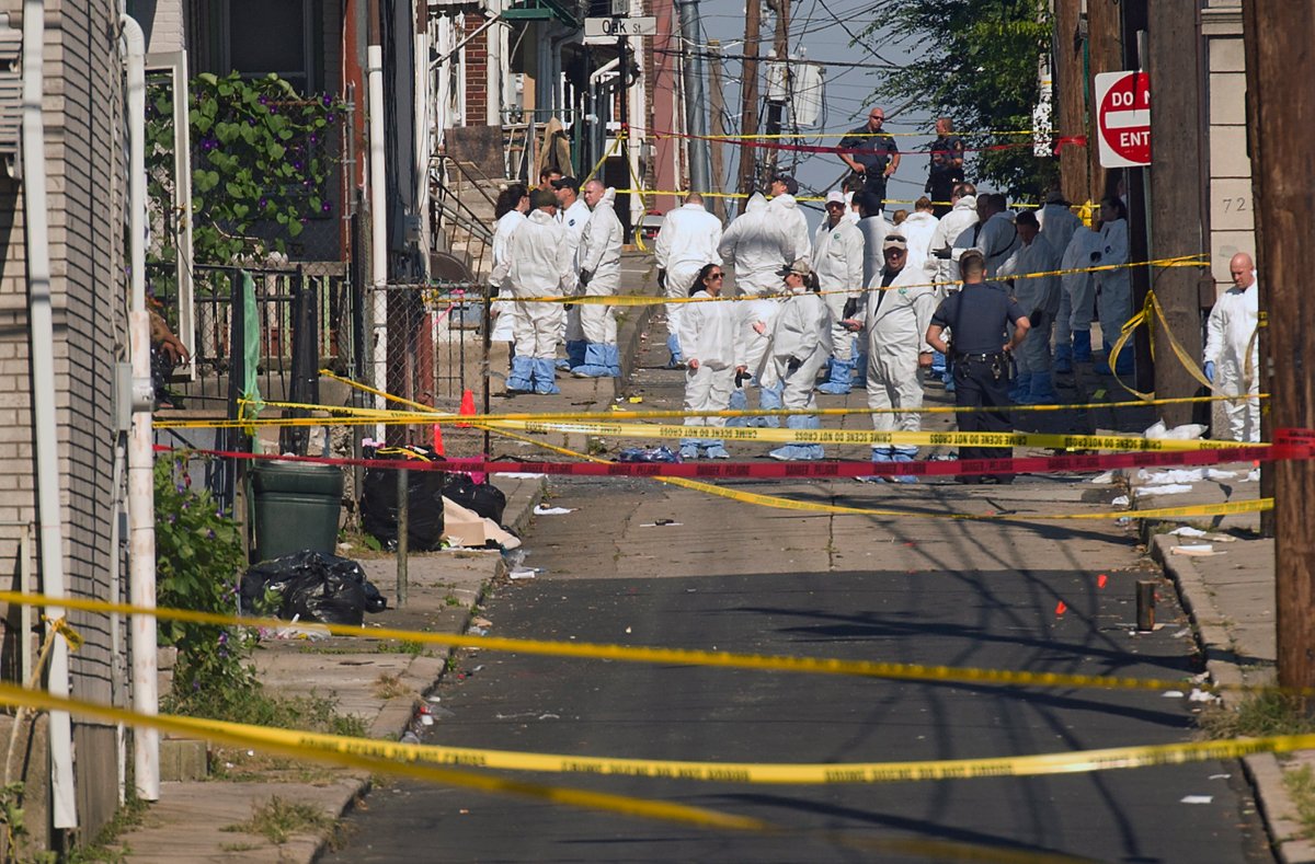 Police join members of the ATF and the FBI as they investigate North Hall Street in Allentown, Pa., Sunday, Sept. 30, 2018, after a fiery car explosion rocked the neighborhood on Saturday.