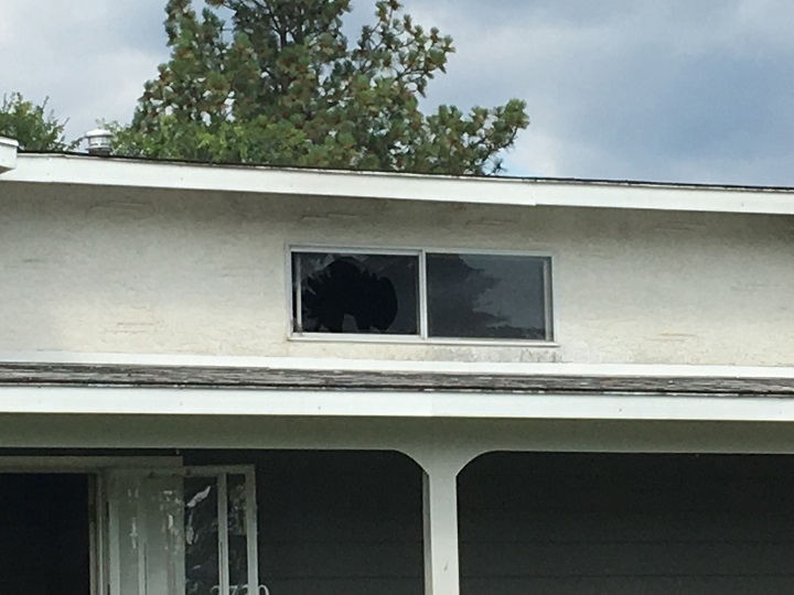 A broken window at the house fire in West Kelowna.