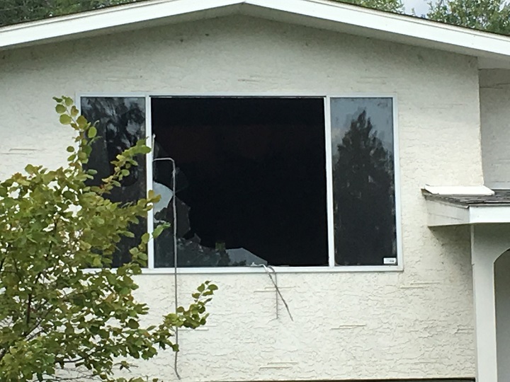 The living room window was smashed open as emergency crews battled this house fire in West Kelowna.