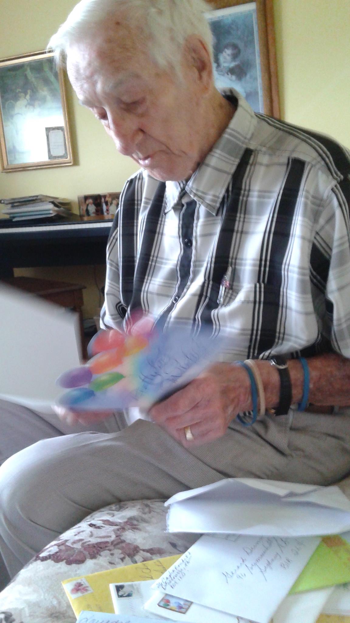 Gerard Dunn, 91, opening one of the dozens of cards he's already received after his daughter put out a call on Twitter for mail for his upcoming birthday.