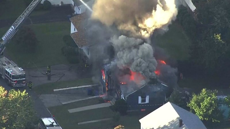 In this image take from video provided by WCVB in Boston, firefighters battle a raging housefire in Lawrence, Mass., a suburb of Boston, on Thursday, Sept. 13, 2018. Emergency crews are responding to what they believe is a series of gas explosions that have damaged homes across three communities north of Boston.
