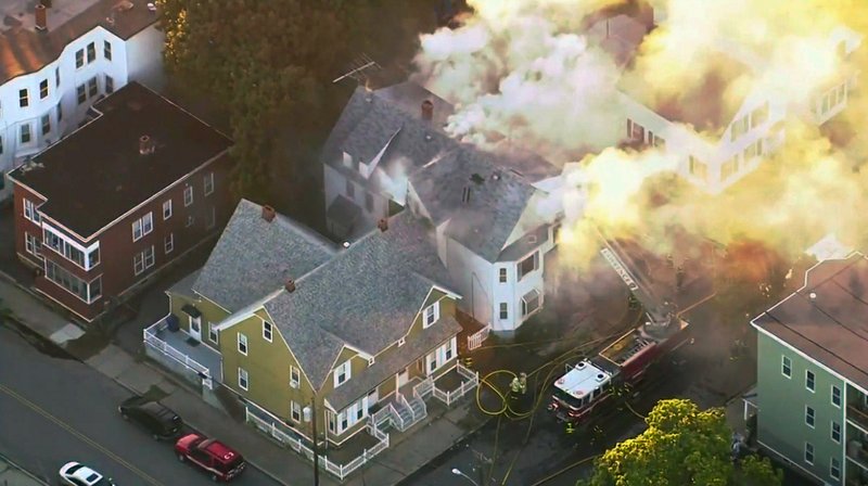 In this image take from video provided by WCVB in Boston, firefighters battle a large structure fire in Lawrence, Mass, a suburb of Boston, Thursday, Sept. 13, 2018. Emergency crews are responding to what they believe is a series of gas explosions that have damaged homes across three communities north of Boston.