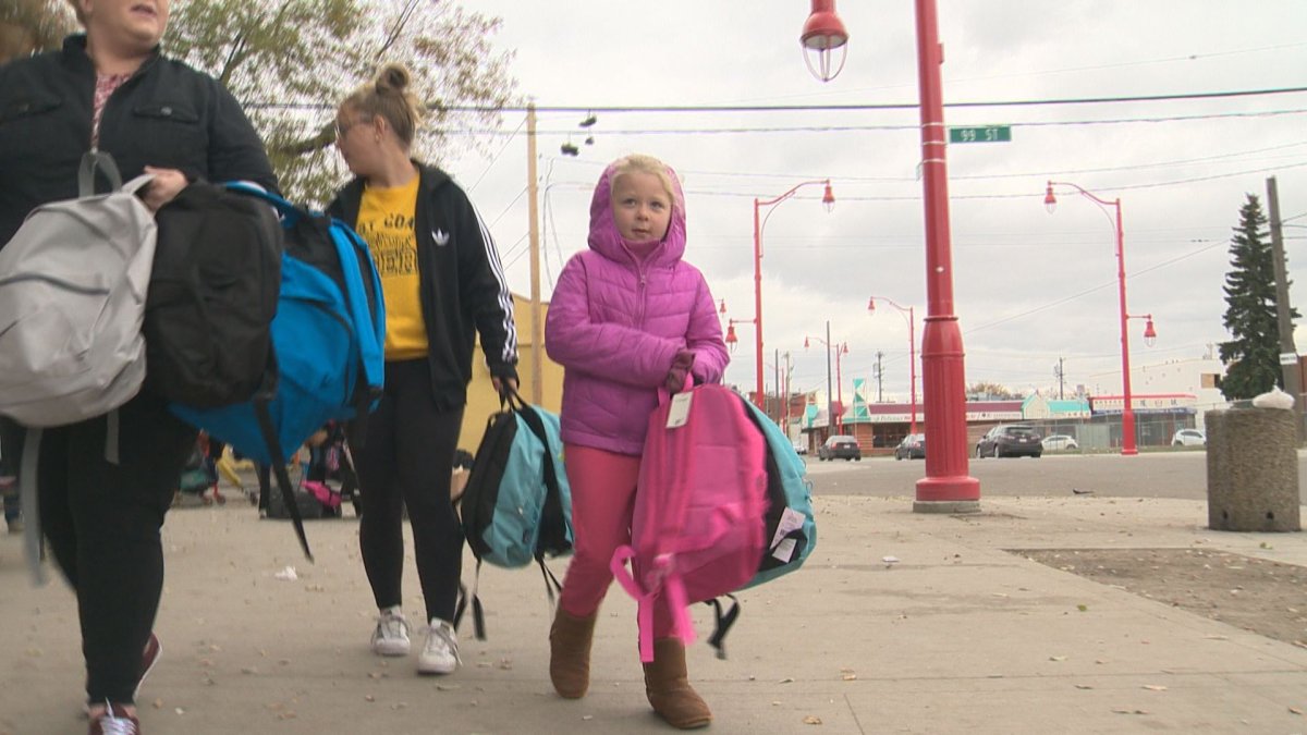 Brooklyn Valaire hands out backpacks outside Edmonton's Hope Mission.