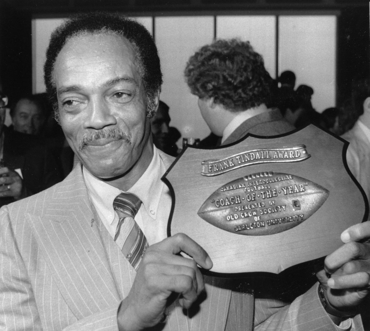 Head Coach of the McMaster University Marauders football team, Bernie Custis, shows off the award for Canadian Interuniversity Athletic Union coach of the year in Toronto on November 18, 1982.
