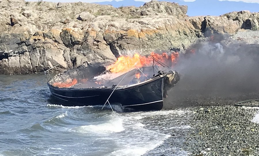 Three people were rescued from the waters off Nanaimo after this boat caught fire on Thursday.