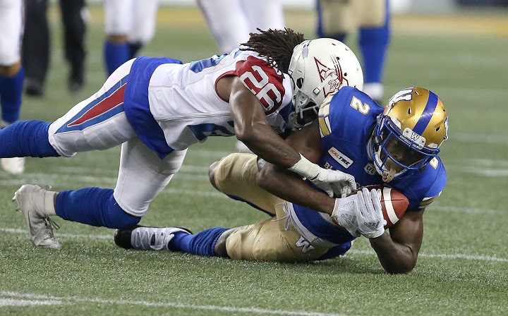 Winnipeg Blue Bombers WR Kenbrell Thompkins makes a catch under pressure from Montreal Alouettes DB Tevaughn Campbell during fourth quarter CFL action in Winnipeg on Friday, September 21, 2018. 