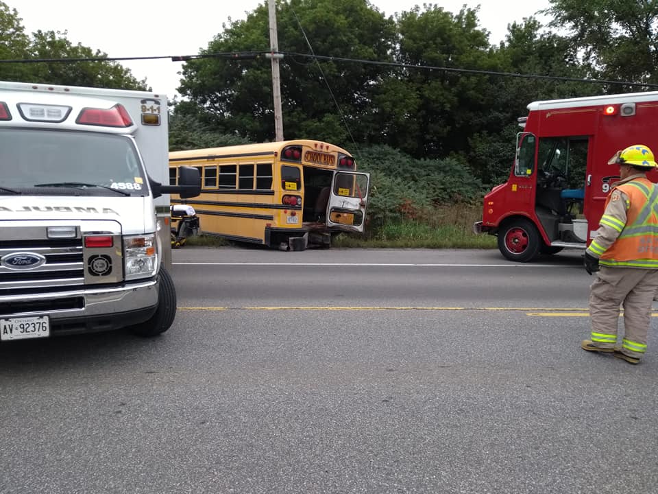 A damaged school bus is seen off to the side of Highway 34 after a collision with a tractor trailer on Wednesday morning.