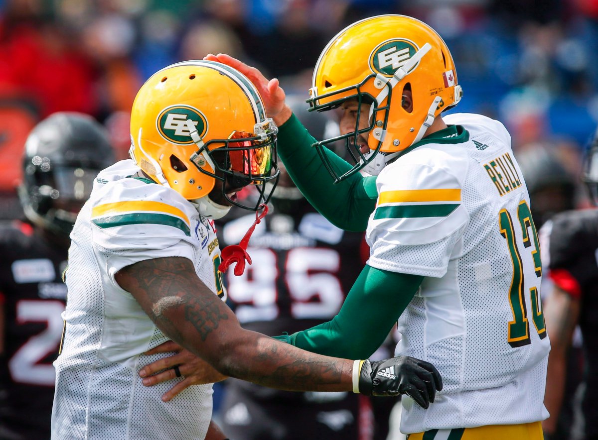 Edmonton Eskimos' C.J. Gable, left, celebrates his touchdown with quarterback Mike Reilly during first half CFL football action in Calgary, Monday, Sept. 3, 2018.