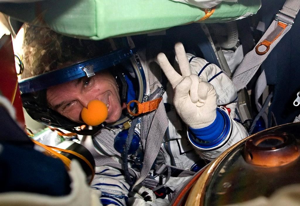 Space tourist Canadian billionaire and clown Guy Laliberte shows A victory sign while sitting inside the Soyuz TMA-14 spacecraft shortly after his landing near the town of Arkalyk, Kazakhstan, on Sunday, Oct. 11, 2009. Laliberté ended a legal challenge over a tax bill for his 2009 space flight. Monday, June 1, 2020.