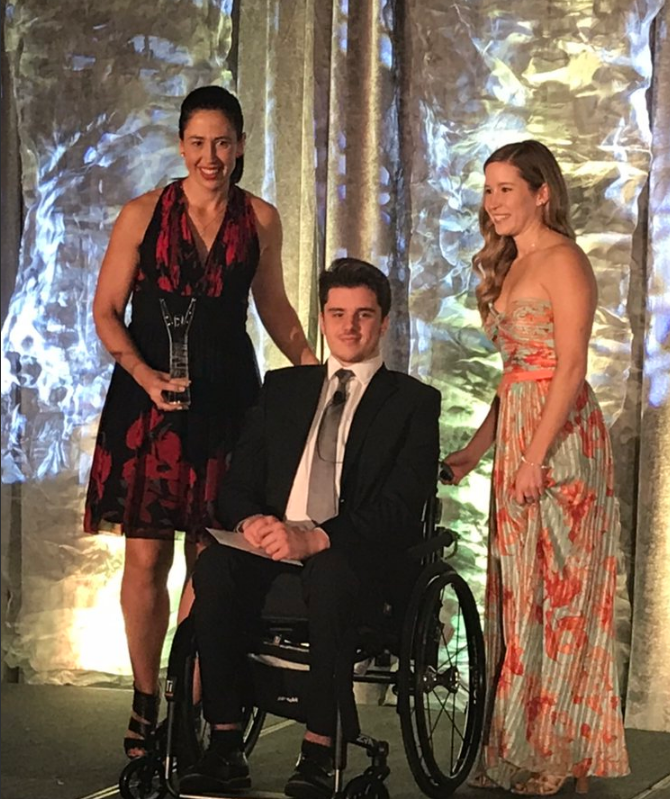 Ryan Straschnitzki presents team Jennifer Jones with Canada Sport Award.